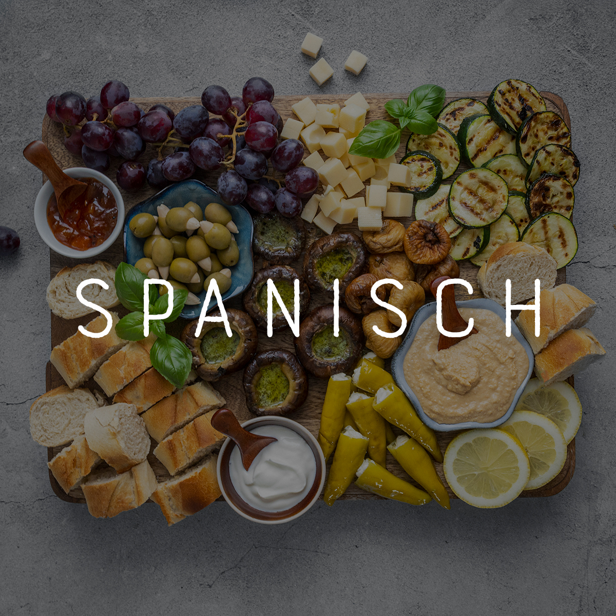 Bild mit einer Platte spanischer Spezialitäten und der Headline "Spanisch"